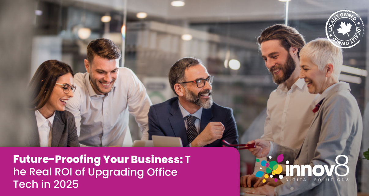 Business professionals smiling and collaborating around a laptop during a team meeting in a modern office.