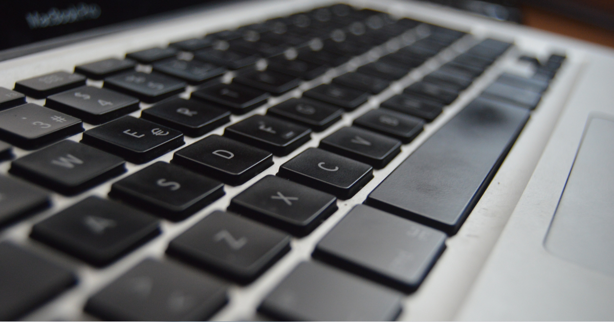 Close-up view of a black laptop keyboard, highlighting the keys and sleek design.